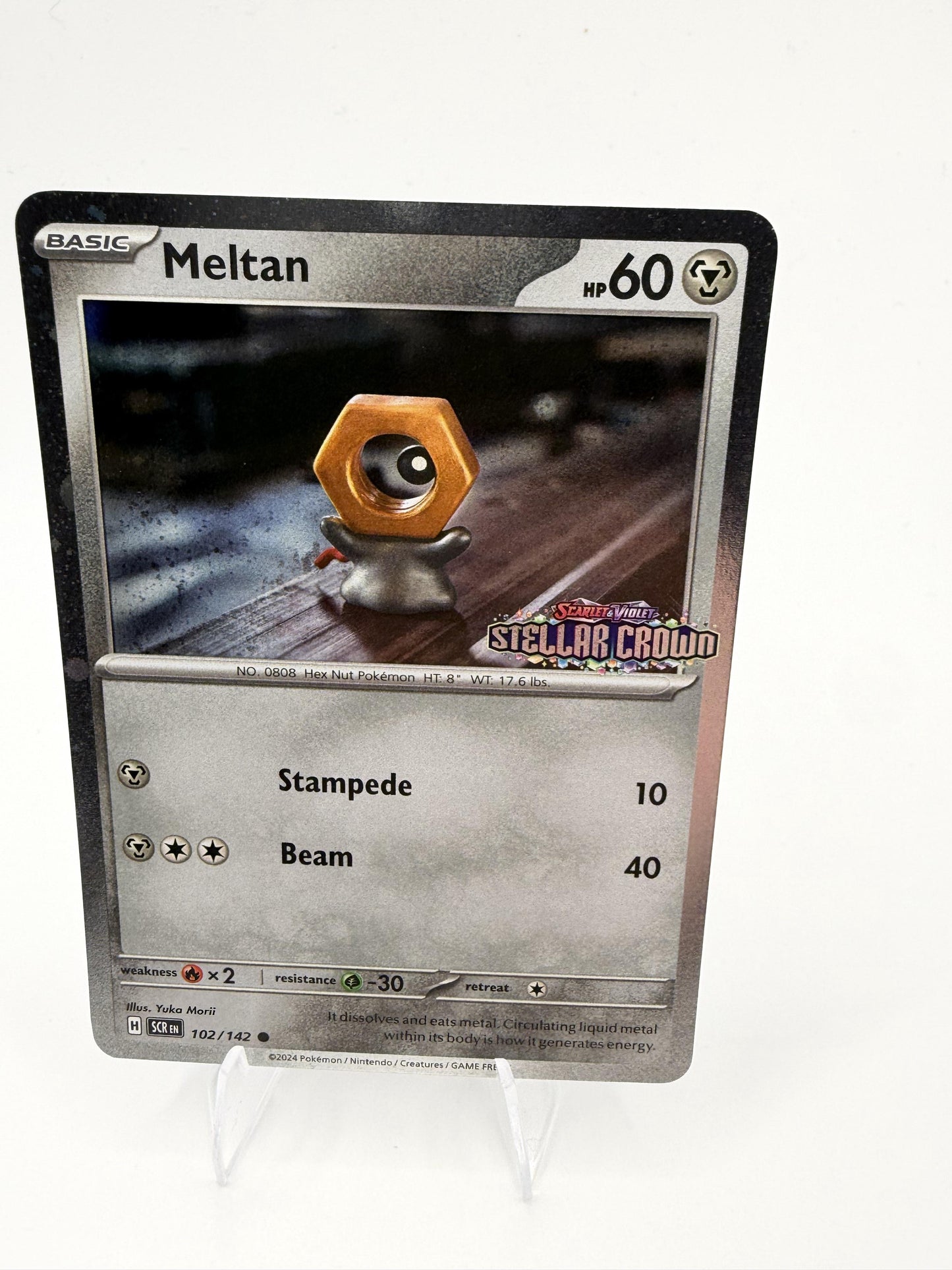 Meltan 102/142 Stellar Crown Cosmos Holo Pokemon 2024 Promo NM