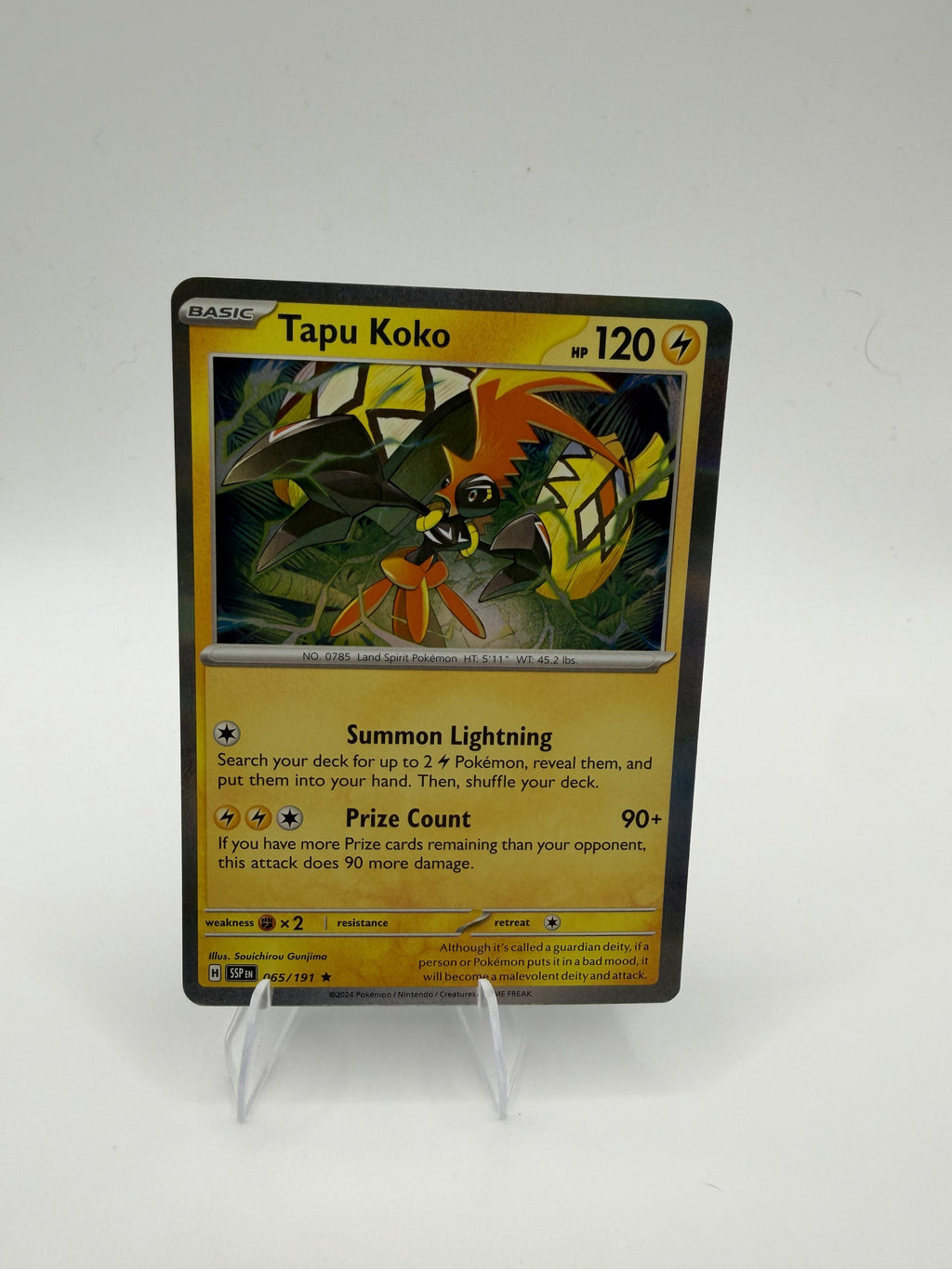 2024 Pokemon Tapu Koko 065/191 Surging Sparks Reverse Holo Rare TCG NM