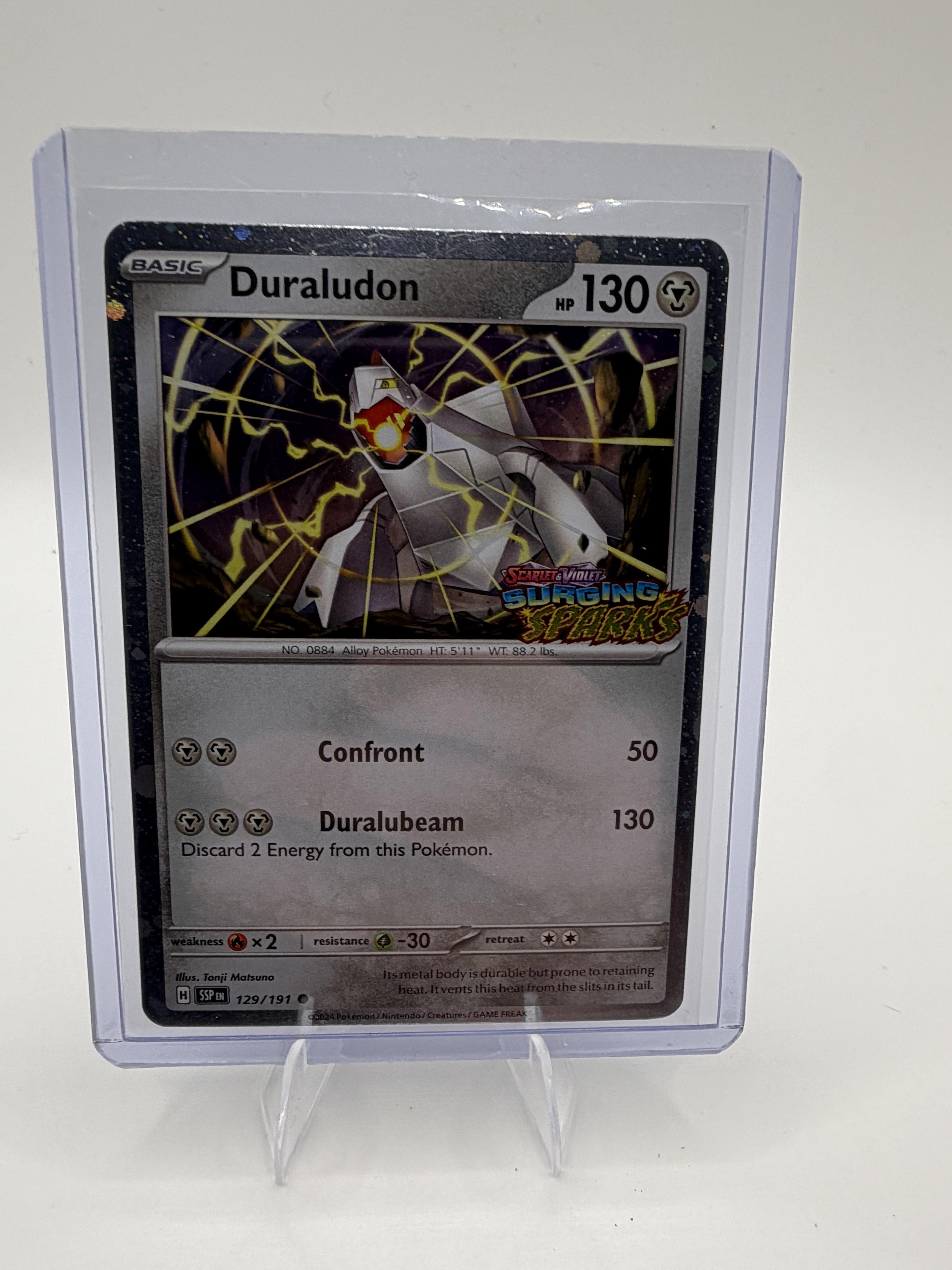 Duraludon 129/191 - Surging Sparks Set Stamped - Cosmos Holo - Pokemon - NM